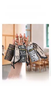Close-up of three mini leather coin purses with bear prints and decorative scarves