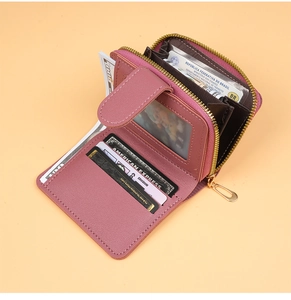 Detail view of pink women's wallet showing internal card slots and gold zipper