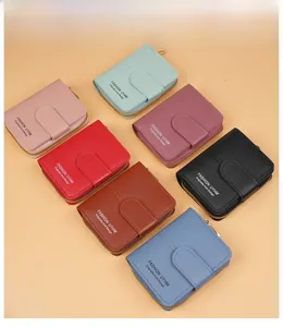 Flat lay of colorful women's PU leather short wallets with snap button and U-zipper closure