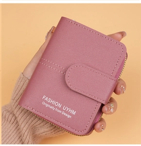 Detail of compact pink purple faux leather wallet with zipper and snap closure