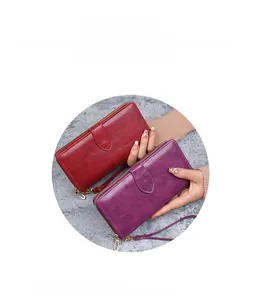 Détails de portefeuilles en cuir huilé rouge et violet avec fermeture éclair et dragonne
