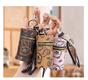 Close-up of mini leather coin purses with bear prints and decorative silk scarves