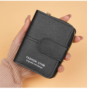 Close-up of black leather wallet with lychee texture and secure metal zipper detail