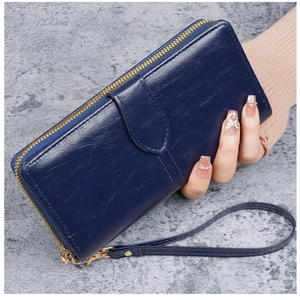 Vue détaillée du portefeuille bleu foncé en cuir ciré avec fermeture éclair dorée