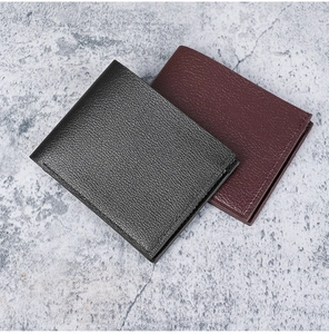 Detailed view of men's bifold wallets in black and burgundy lychee pattern leather