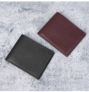 Detailed view of men's short PU leather wallets in black and burgundy with litchi texture
