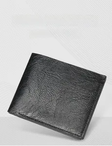 Close-up of minimalist black men's short bifold wallet with pebble leather texture