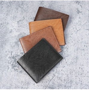 Stacked short bifold wallets in four leather colors showing premium texture and finish