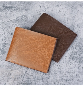 Two bifold men's short wallets in brown with vintage crackle texture on grey stone