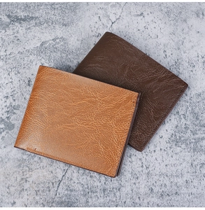 Detailed view of horizontal bi-fold men's wallets in brown textured leather finish