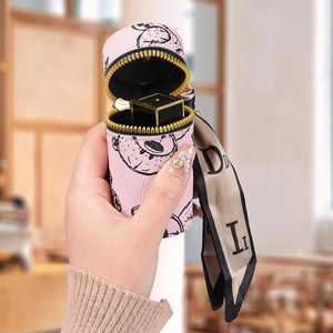 Pink cylinder leather lipstick case with bear pattern and silk scarf keychain detail