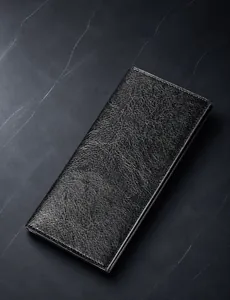 Detailed close-up of long black leather wallet with premium lychee grain and fine stitching