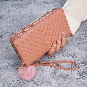 Pink quilted V-pattern long wallet with double zippers, wrist strap and fur ball charm