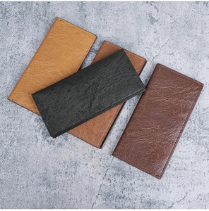 Detailed view of four retro long wallets in black and brown with vintage leather texture