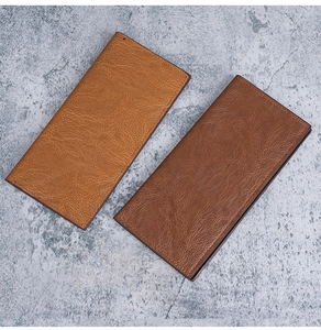 Close-up of slim leather wallets in tan and coffee showing natural grain and neat stitching