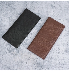 Detail view of vintage lychee texture and hand-stitched edges on leather long wallets