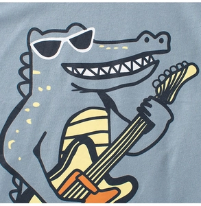 Close-up of kids t-shirt showing cartoon crocodile with guitar on grey knit fabric