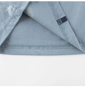 Detailed close-up showing the double-needle stitching and soft cotton fabric of the blue T-shirt