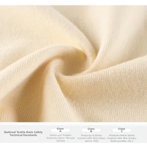 Close-up of soft beige knit cotton fabric showing detailed texture and quality