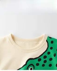 Detail of a beige crew neck t-shirt with ribbed collar and green monster print