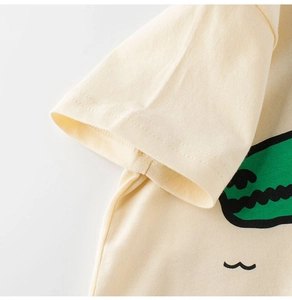 Close-up of double-stitched sleeve and cartoon print on soft yellow cotton kids T-shirt