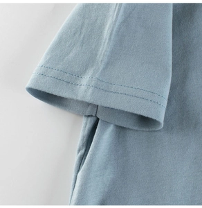 Detail of high-quality cotton knit stitching on baby blue dinosaur toddler t-shirt sleeve