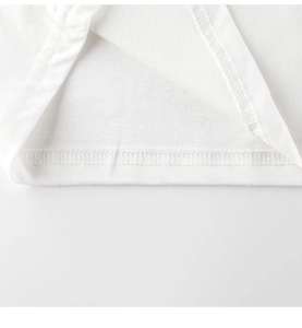 Close-up of double-stitched hem on white cotton t-shirt for kids showing textile detail