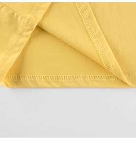 Close-up of high-quality double-needle stitching on the yellow cotton kids' T-shirt hem