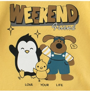 Detail of yellow cotton toddler shirt featuring cute cartoon penguin, chick and dog print