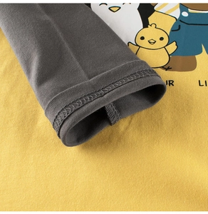 Detailed macro view of cotton sleeve cuffs and cute cartoon print on kids t-shirt