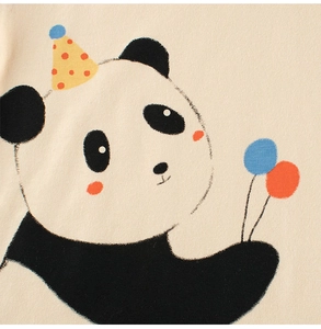 Close-up of cute panda print with party hat and balloons on beige cotton kids t-shirt