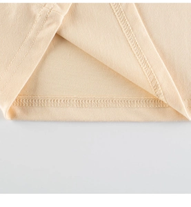 Macro detail of fine double-needle stitching on light beige cotton knit hem