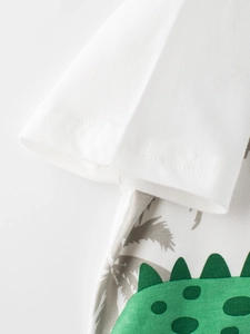 White cotton toddler t-shirt with green dinosaur print and tropical palm trees silhouette