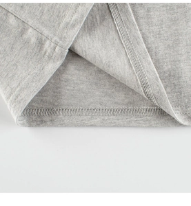 Detail shot of marl grey cotton knit fabric with reinforced double stitching hem