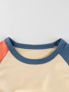 Kids long sleeve crew neck t-shirt with blue and orange raglan sleeves and cotton fabric