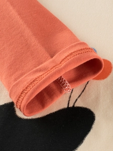 Kids long sleeve cotton T-shirt featuring terracotta ribbed cuffs and cartoon patterns