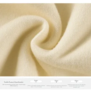 Detailed macro view of soft cream knit fabric texture with textile safety information