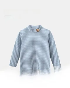 Detail of baby striped shirt with teddy bear embroidery and mock neck cotton fabric