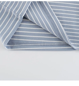 Detail of blue and white striped cotton shirt showing double-needle hem and fine stitching