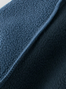 Close-up of deep blue fleece lining with detailed stitching for children's sweatshirt