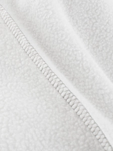 Close-up of white polar fleece fabric showing soft texture and precision stitching