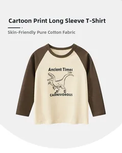 Close-up of boys raglan sleeve cotton t-shirt featuring a hand-drawn dinosaur print