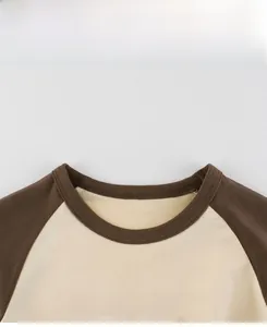 Detail of crew neck and Ancient Times T-Rex print on cotton raglan sleeve kids t-shirt