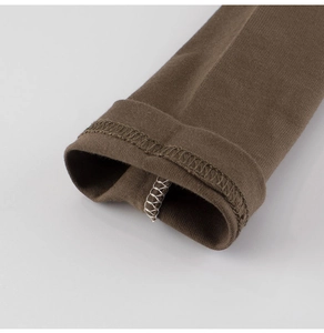 Close-up of brown cotton knit sleeve with detailed stitching and durable hemmed cuff