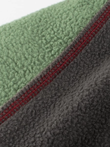 Kids fleece sweatshirt featuring green and grey patchwork with red contrast stitching