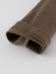 Detailed view of dark brown knit cotton boy's long-sleeve T-shirt sleeve cuff stitching