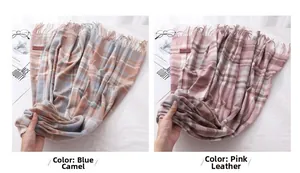 Detail of blue camel and dusty pink plaid scarves with soft tassels and woven texture