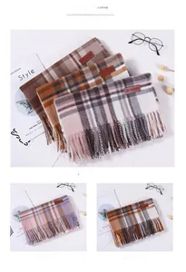 Detailed view of fashion label on plaid scarves with soft fringe and thick texture