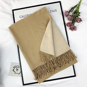 Two-tone cashmere-style scarf in khaki and beige with elegant tassels on white background
