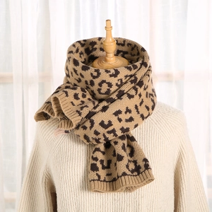 Detail shot of the thick leopard print knit scarf texture and ribbed edge finish